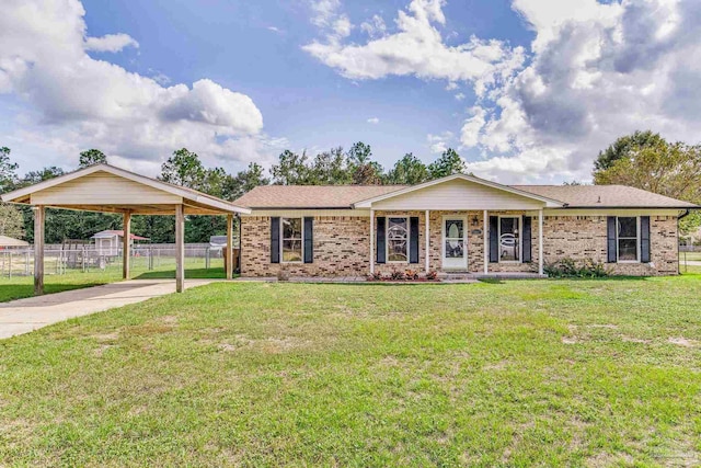 ranch-style home with a front lawn, fence, brick siding, and driveway