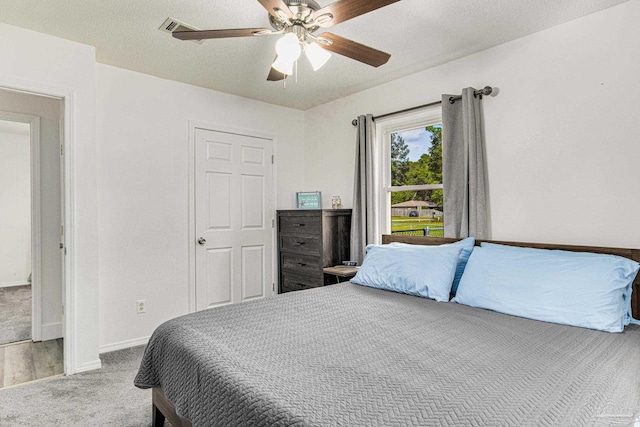 carpeted bedroom featuring a ceiling fan and baseboards