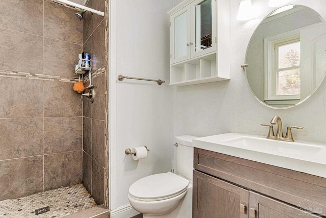 full bath with vanity, a shower stall, and toilet