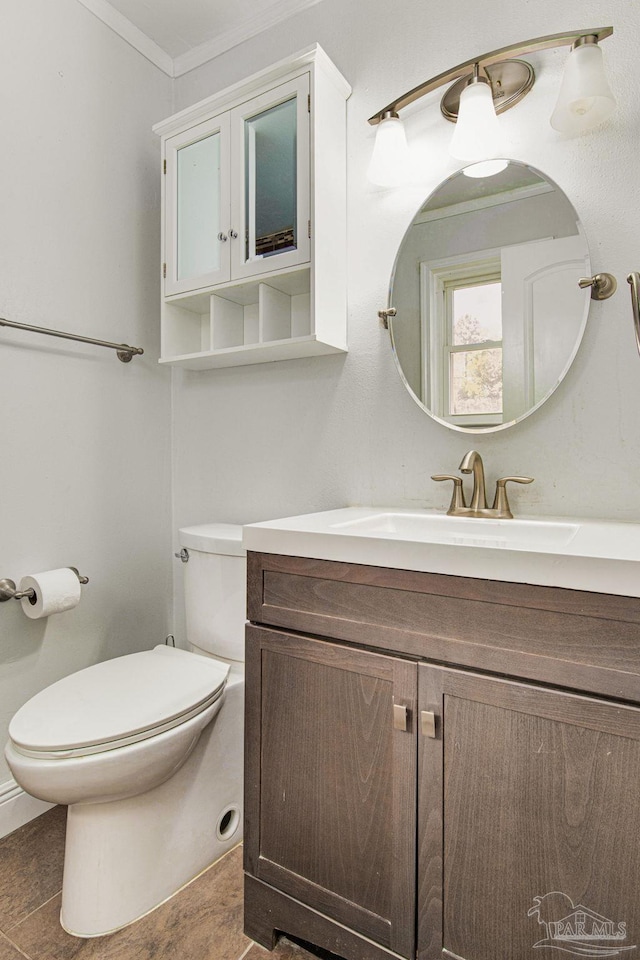 bathroom with vanity, crown molding, and toilet