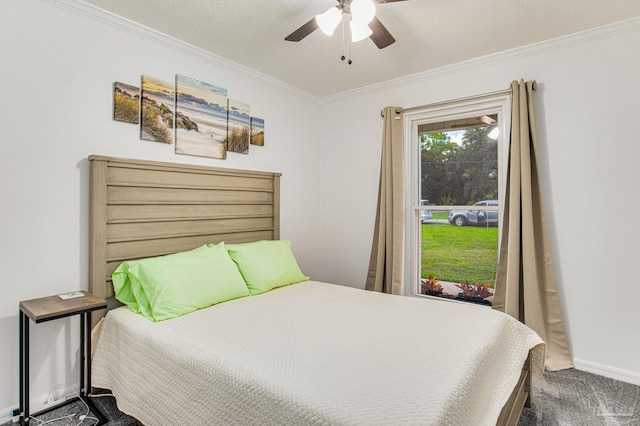 carpeted bedroom featuring baseboards, crown molding, and ceiling fan