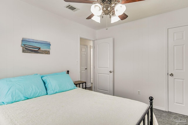 carpeted bedroom with a ceiling fan and visible vents