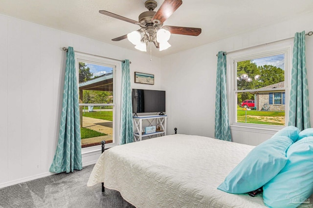 bedroom featuring multiple windows, carpet, and ceiling fan