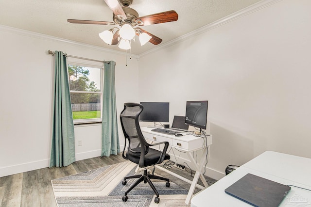 office space featuring baseboards, crown molding, ceiling fan, and wood finished floors