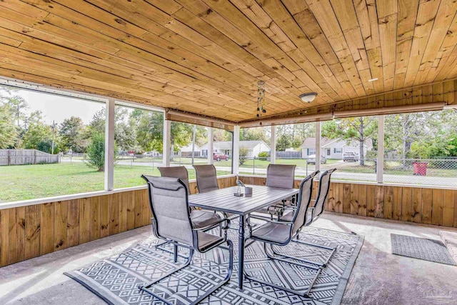 sunroom / solarium featuring lofted ceiling and wood ceiling