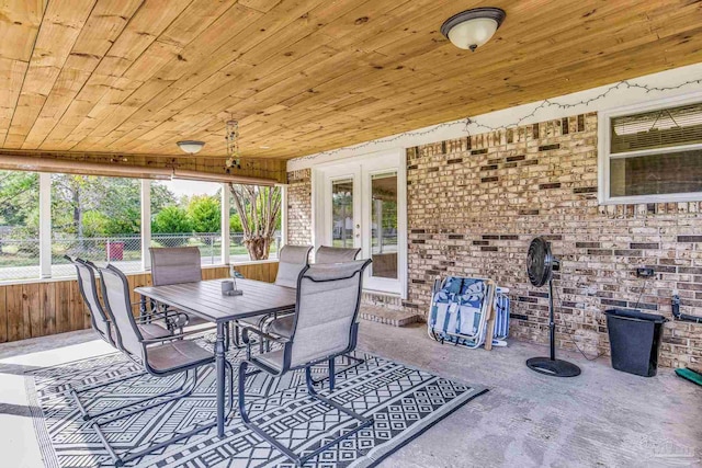 exterior space with french doors, outdoor dining area, and fence