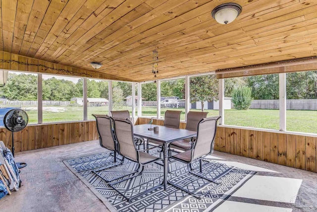 sunroom / solarium featuring a healthy amount of sunlight, wooden ceiling, and vaulted ceiling