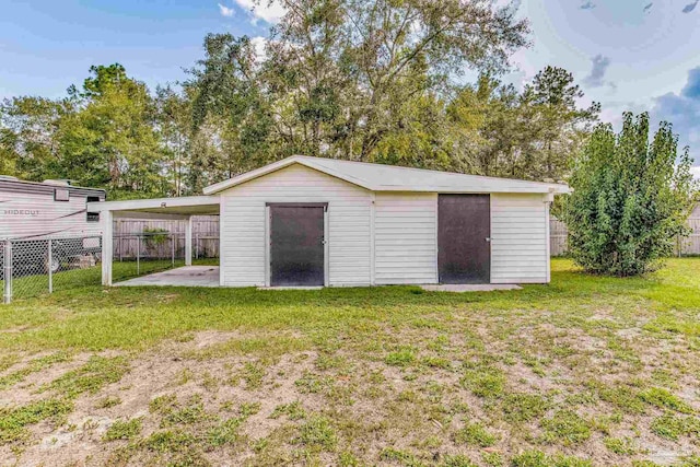 garage featuring a carport and fence