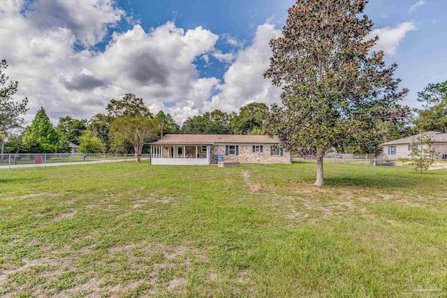 exterior space with a front yard and fence