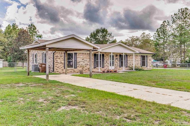 ranch-style house featuring brick siding, driveway, a front lawn, and fence