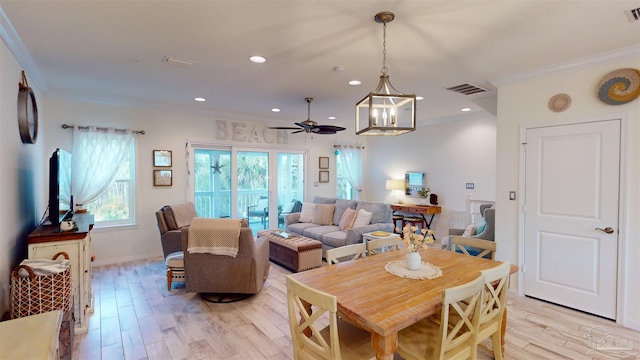 dining space with crown molding, ceiling fan, and light hardwood / wood-style flooring