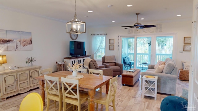 dining area with ceiling fan, ornamental molding, and light wood-type flooring