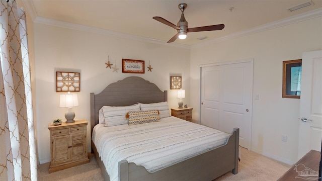 carpeted bedroom featuring ornamental molding, a closet, and ceiling fan