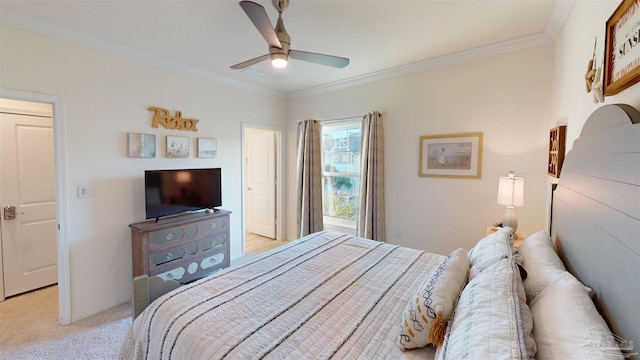 carpeted bedroom featuring ornamental molding and ceiling fan