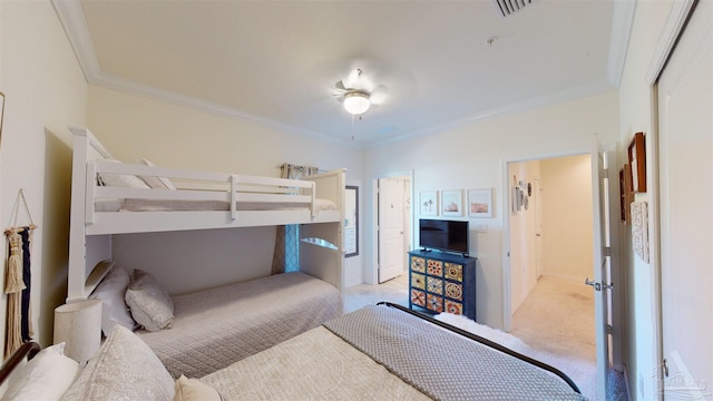 carpeted bedroom with ceiling fan and ornamental molding