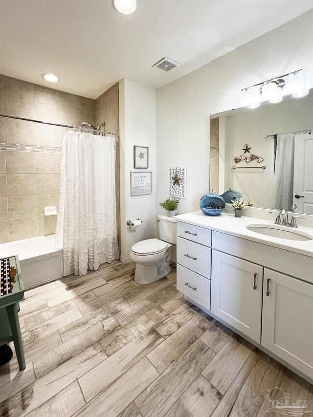 full bathroom featuring vanity, shower / tub combo with curtain, and toilet