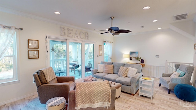 living room featuring crown molding, ceiling fan, and light hardwood / wood-style floors