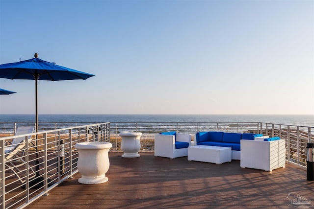 deck at dusk featuring outdoor lounge area and a water view