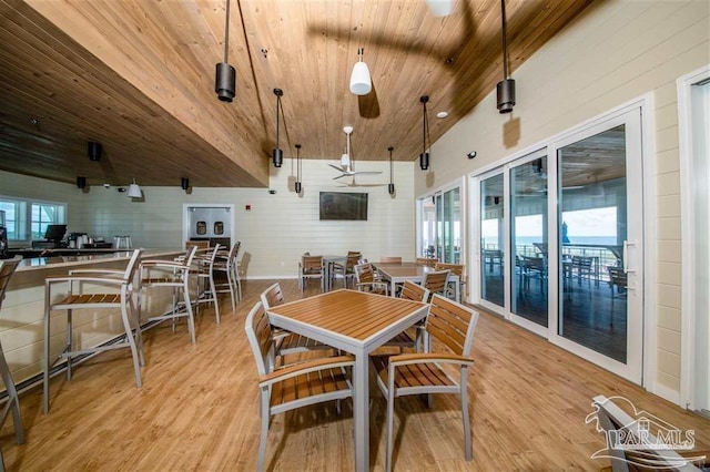 dining room with lofted ceiling, wooden ceiling, and light hardwood / wood-style floors