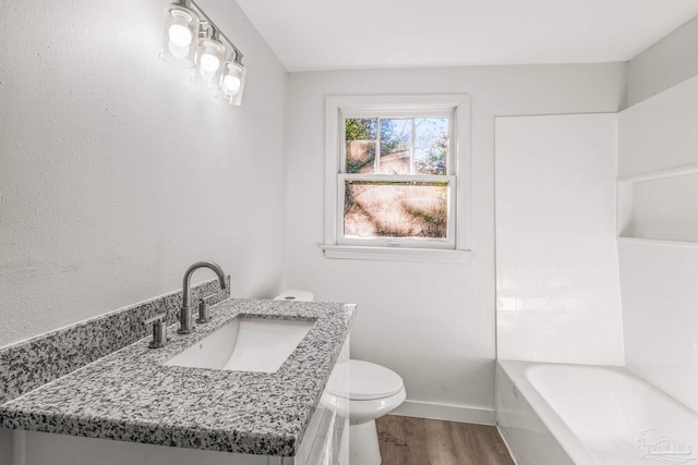 bathroom with hardwood / wood-style floors, vanity, and toilet