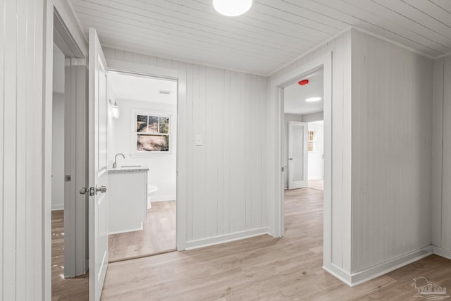 hallway featuring light hardwood / wood-style floors and sink