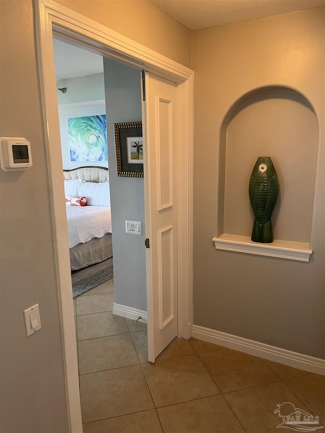 hall featuring light tile patterned flooring