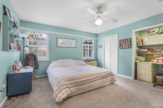 bedroom featuring a ceiling fan, a closet, baseboards, and carpet flooring