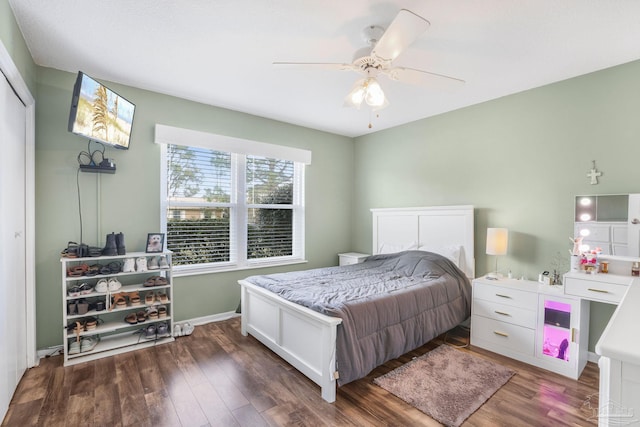 bedroom featuring ceiling fan, wood finished floors, and baseboards