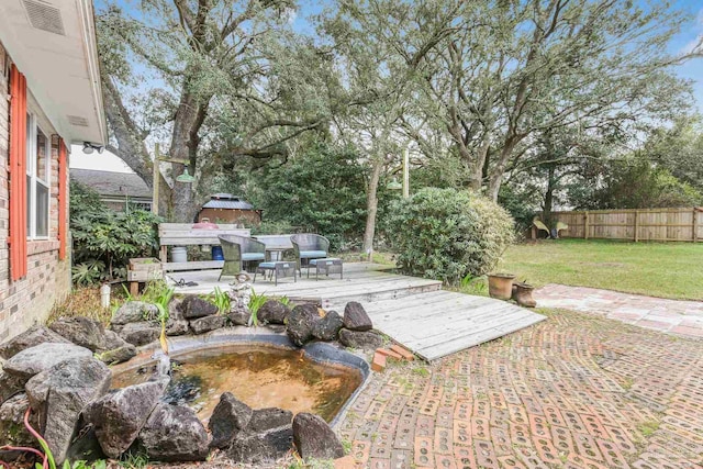 view of patio featuring fence and a wooden deck