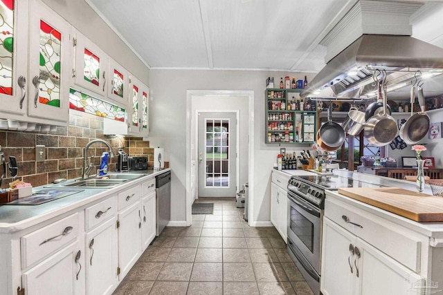 kitchen with decorative backsplash, island exhaust hood, stainless steel appliances, light countertops, and a sink