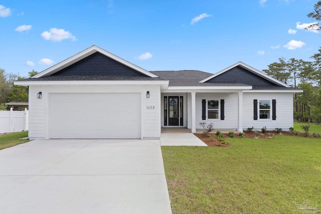 ranch-style home featuring fence, a front yard, a shingled roof, concrete driveway, and an attached garage