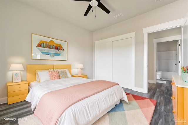 bedroom featuring baseboards, a closet, dark wood-style floors, and visible vents