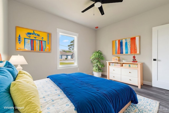 bedroom with baseboards, ceiling fan, and wood finished floors
