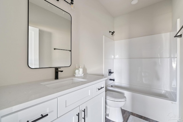 full bathroom featuring bathing tub / shower combination, vanity, toilet, and wood finished floors