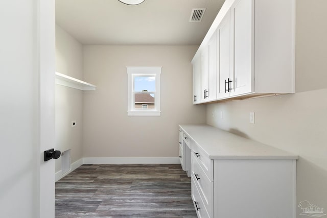 washroom featuring visible vents, dark wood-style flooring, baseboards, and electric dryer hookup