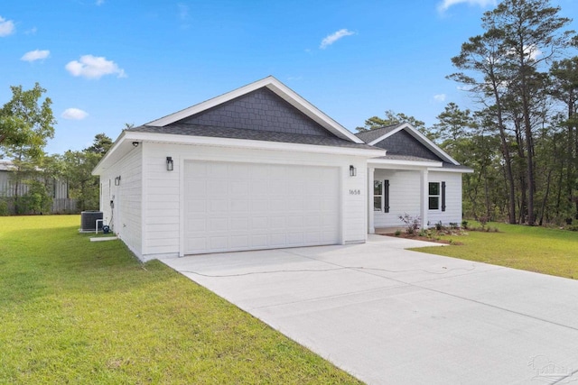 view of front of house with a garage, a front lawn, central AC, a shingled roof, and concrete driveway