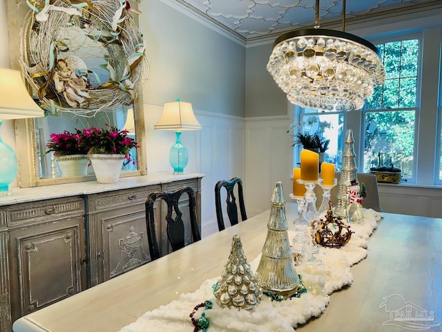 dining space featuring an inviting chandelier and crown molding