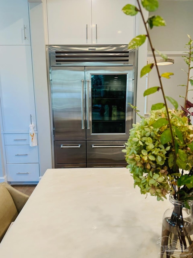 interior space featuring built in refrigerator and white cabinets