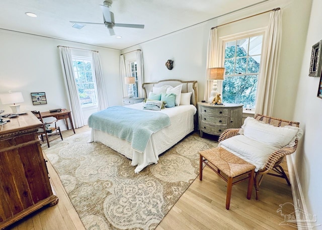 bedroom featuring light hardwood / wood-style floors and ceiling fan