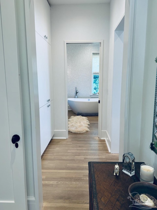 bathroom featuring a tub and wood-type flooring