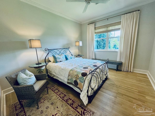 bedroom with ceiling fan, ornamental molding, and hardwood / wood-style floors