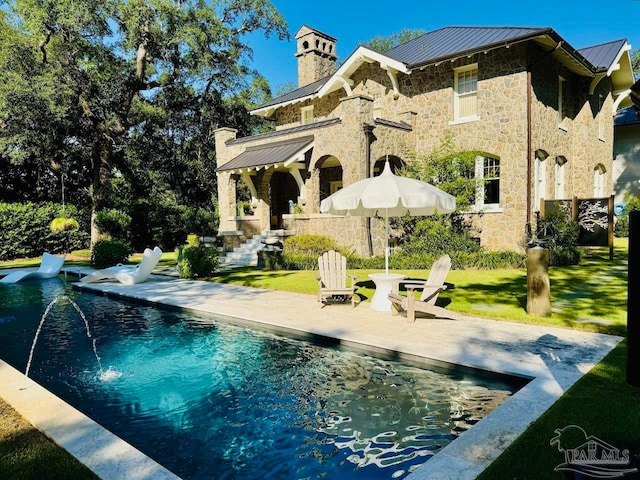 rear view of property featuring a patio and a yard