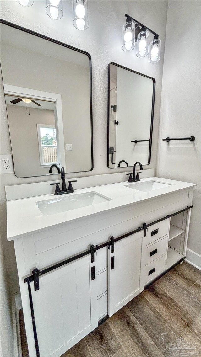 bathroom featuring an enclosed shower, vanity, toilet, and hardwood / wood-style floors