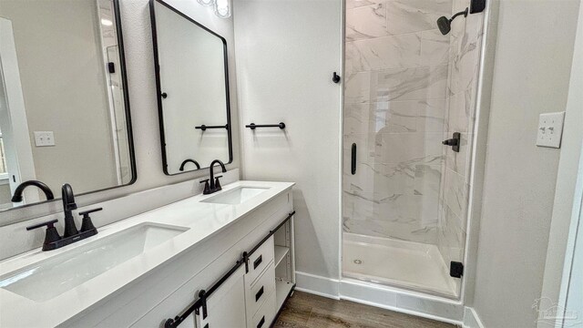 bathroom featuring hardwood / wood-style floors, vanity, and an enclosed shower