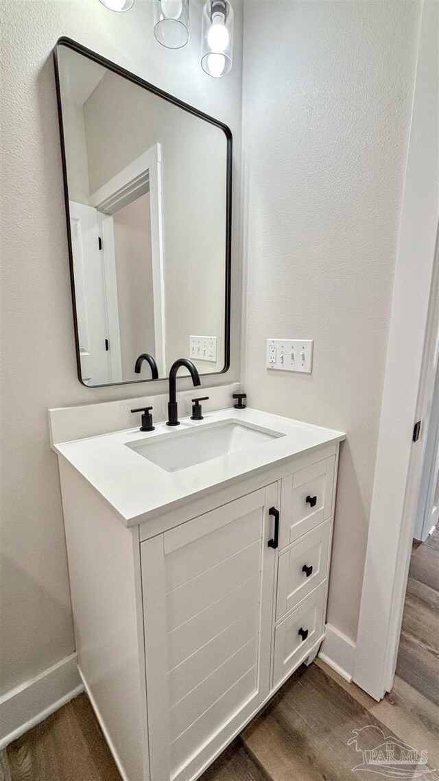 full bathroom with hardwood / wood-style flooring, vanity, toilet, and shower / bathing tub combination