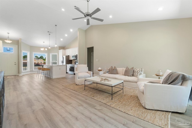 living room featuring high vaulted ceiling, ceiling fan, and light hardwood / wood-style floors