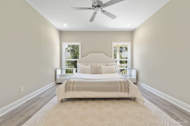 2098 Anna Ct, Milton, FL 32583 - bedroom with multiple windows, light wood finished floors, baseboards, and recessed lighting
