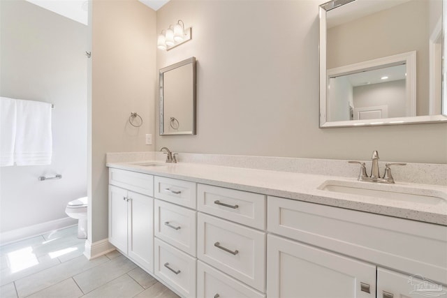 bathroom featuring tile patterned floors, toilet, and vanity