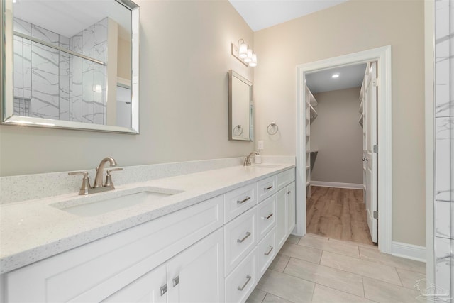 bathroom featuring vanity, an enclosed shower, and tile patterned floors