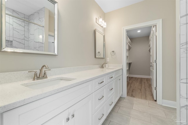 2098 Anna Ct, Milton, FL 32583 - full bath featuring a marble finish shower, double vanity, baseboards, and a spacious closet